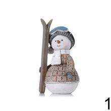 Snehuliak lyžiar s lyžami, béžovo-modro-sivá výbava.