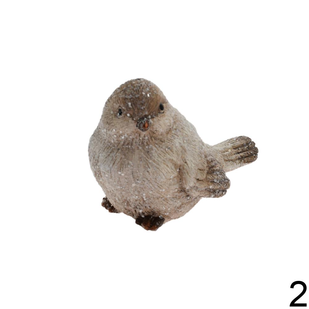 Keramické figurky ptáčků v bílé a zelené barvě.