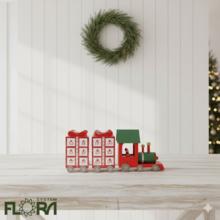 Adventný kalendár v tvare vláčika z dreva v červenej, bielej a zelenej farbe.