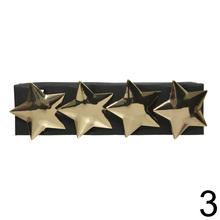 Zlaté obrúčky na servítky s motívmi soba, stromčeka a hviezdy.