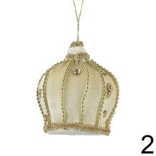 Závesná ozdoba v tvare korunky v červenej a bielej farbe.