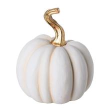 Bílá keramická dýně se zlatým stonkem.