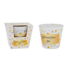 Vonná svíčka ve skle s motivem zlaté a stříbrné hvězdy.