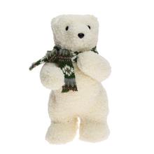 Bílý stojící medvěd se zeleným šálkem.