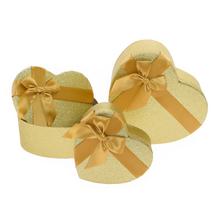 Dárkové krabičky ve tvaru srdce, zlaté matné, s mašlí.