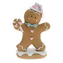 Perníček s lízátkem v bílé, růžové, tyrkysové a hnědé barvě.