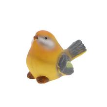 Keramická ptáček v žluté barvě.