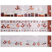 Vánoční fólie na okna s ptáčky a dárky.