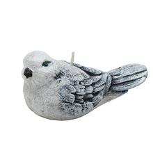 Velká šedá figurka ptáčka na svíčku.