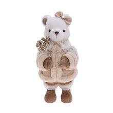 Textilní figurka medvídka v béžovém kabátku.